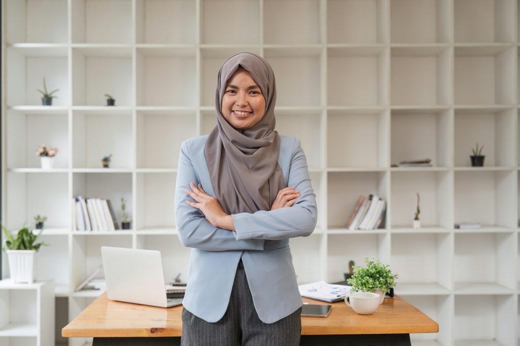 Business Woman Muslim Woman. Portrait Of Confident Arabic Businesswoman In Hijab Standing Workplace